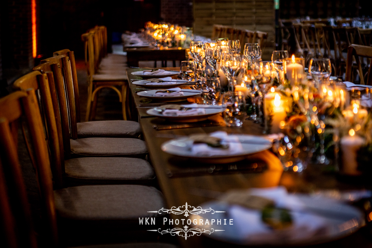 Détails de la décoration de table du mariage de Claire et Corentin, avec des fleurs fraîches, des bougies et des éléments champêtres.